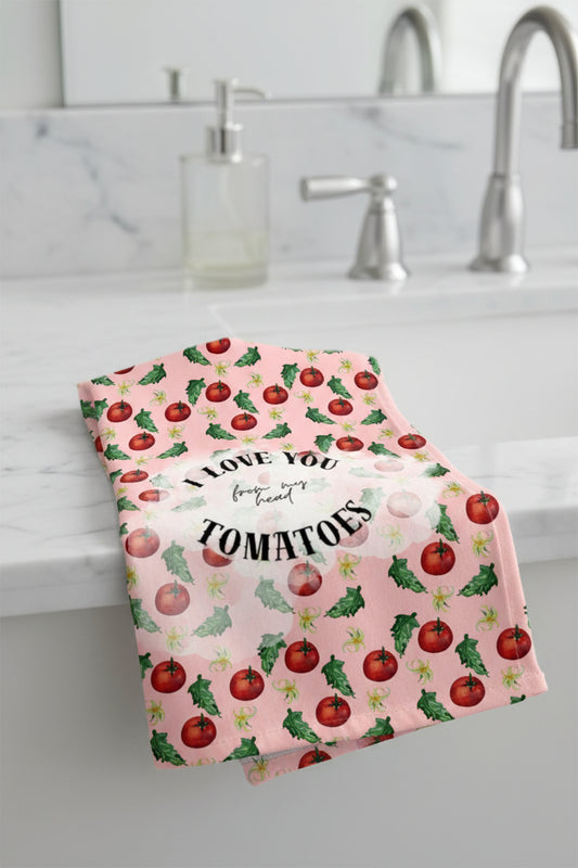 A pink square graphic with a repeating pattern of red tomatoes and green leaves, overlaid with a central white oval containing the text 'I LOVE YOU from my head TOMATOES'.