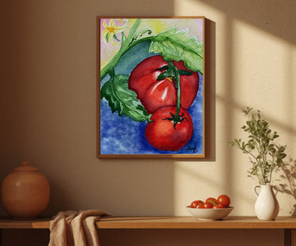 A framed watercolor painting of red tomatoes on a vine with green leaves, hanging on a beige wall above a wooden shelf with decorative props.